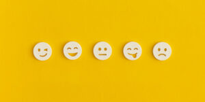 Emoticon smile on a yellow background. Customer feedback.